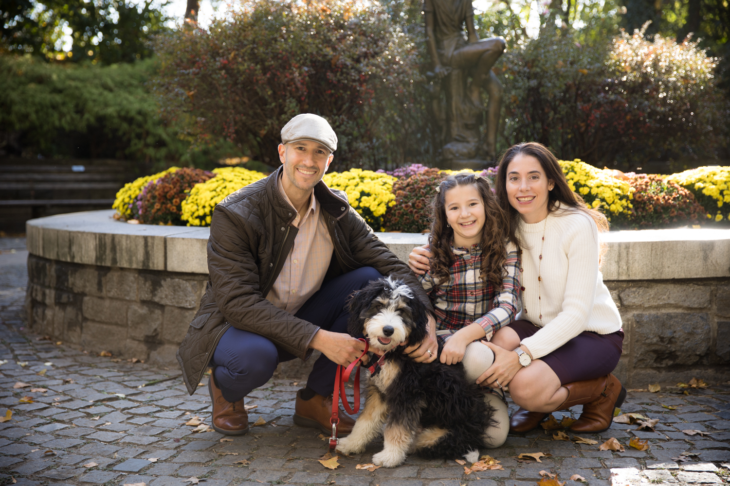 Two Adults, a Girl, and Their Pup at Carl Schurz